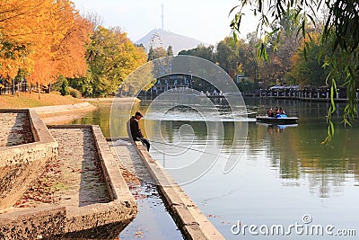 Autumn in the Central Recreation Park by the pond in Almaty. Editorial Stock Photo